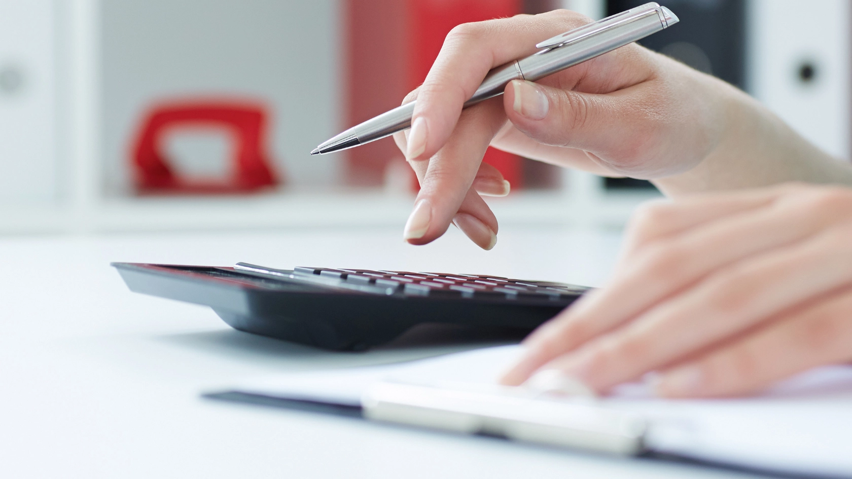 Frau rechnet mit einem Taschenrechner