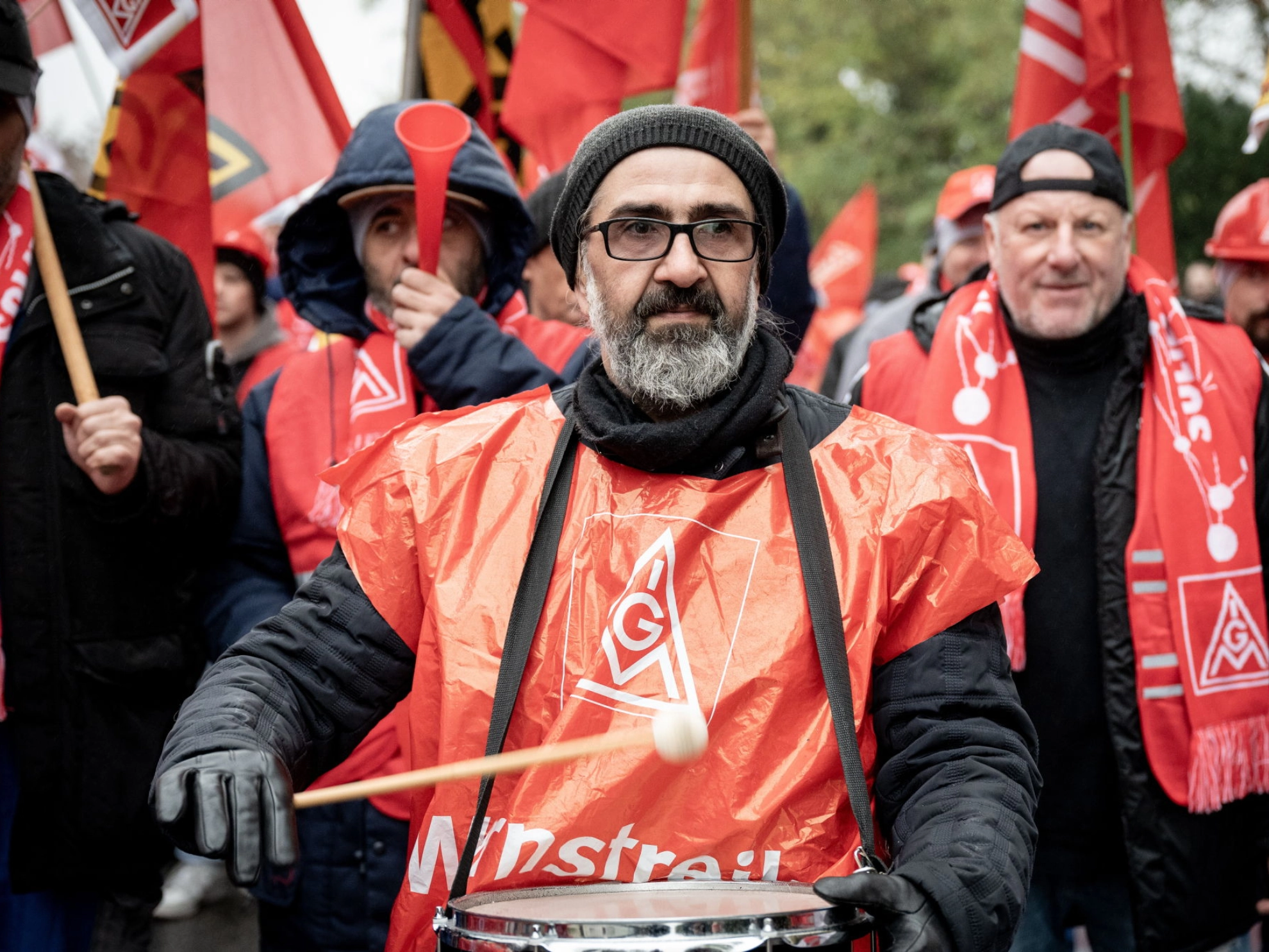 Ein Mann schläft beim Warnstreik in der Metall-Tarifrunde auf seine Trommel